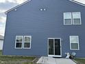 Rear exterior view of home showing sliding glass door leading to patio at 1303 Eton Way, Avon, IN 46123