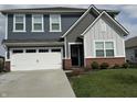 Charming two-story home with a well-manicured lawn, a two-car garage, and a welcoming front entrance at 1303 Eton Way, Avon, IN 46123