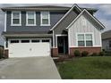 Charming two-story home with a well-manicured lawn, a two-car garage, and a welcoming front entrance at 1303 Eton Way, Avon, IN 46123