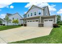 Inviting two-story home with three-car garage and spacious driveway in a suburban setting at 13567 Moorcroft Dr, Fishers, IN 46037