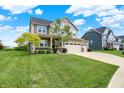 Beautiful two-story home with an attached garage and lush green lawn in a friendly neighborhood at 13567 Moorcroft Dr, Fishers, IN 46037