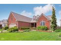 Beautiful brick home with lush landscaping, well-manicured lawn, and inviting curb appeal at 1361 Trescott Dr, Westfield, IN 46074