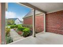 Inviting covered front porch with brick facade and manicured landscaping offers curb appeal at 1361 Trescott Dr, Westfield, IN 46074
