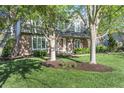 Beautiful two-story brick and siding home with lush lawn and mature trees at 13948 Silver Stream Dr, Carmel, IN 46032