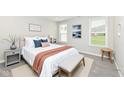 Serene bedroom with soft colors, a comfortable bed, neutral linens, and bright, natural light at 17066 Cole Evans Dr, Noblesville, IN 46060