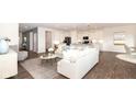Bright and airy living room with hardwood floors, modern white kitchen, and stylish furniture at 20432 Atchison Way, Westfield, IN 46074