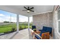 Covered patio featuring brick accents, comfortable seating, and an outdoor ceiling fan at 20432 Atchison Way, Westfield, IN 46074