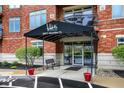 Inviting building entrance with awning, bench seating and beautiful landscaping with views of Morse Lake at 20971 Shoreline Ct # 306, Noblesville, IN 46062