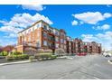 Expansive view of the condo complex with private balconies, green landscaping and ample parking at 20971 Shoreline Ct # 306, Noblesville, IN 46062
