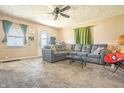 Inviting living room featuring comfortable seating, neutral walls and carpet, and an abundance of natural light at 218 E Mechanic St, Shelbyville, IN 46176