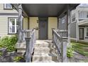 Inviting front porch with stylish gray accents and well manicured landscaping at 2225 Alabama St, Indianapolis, IN 46205