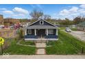 Inviting single-story home featuring a cozy front porch and a well-maintained front yard at 2349 Indianapolis Ave, Indianapolis, IN 46208