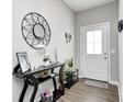 The entryway features a decorative table with mirror, decor items, and a front door with glass panel at 238 Switchgrass Ln, New Whiteland, IN 46184
