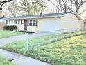 A cozy single-story home with a well-kept yard and a practical attached garage at 2465 N Eaton Ave, Indianapolis, IN 46219