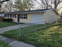 View of the home from the side yard with chain-link fence along property line at 2465 N Eaton Ave, Indianapolis, IN 46219