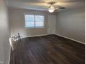 View of the freshly painted living room with new wood-look flooring and ceiling fan at 2465 N Eaton Ave, Indianapolis, IN 46219