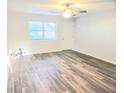 Bright living room featuring modern floors, a ceiling fan, and fresh paint at 2465 N Eaton Ave, Indianapolis, IN 46219