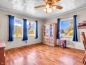 Bright living room featuring hardwood floors, a curio cabinet, and two windows with a great view at 257 N Letterman Rd, Paragon, IN 46166