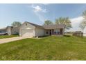 Well-maintained single-Gathering home with attached garage and green lawn at 2680 Woodfield Blvd, Franklin, IN 46131