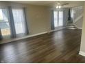 Spacious living room featuring hardwood floors and plenty of natural light from multiple windows at 302 Sanders St, Indianapolis, IN 46225