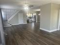Open-concept living area with hardwood floors flowing into the adjacent kitchen at 302 Sanders St, Indianapolis, IN 46225