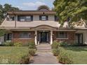 Charming home exterior boasts a welcoming entrance with beautiful architectural details and lush greenery at 3128 E Fall Creek Pkwy N Dr, Indianapolis, IN 46205