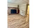 Living room with wood floors, fireplace, and shelving, leading to bathroom at 3136 Foltz St, Indianapolis, IN 46221