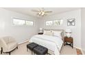 Cozy bedroom featuring a plush bed, accent chair, and soft neutral tones at 319 E Ohio St, Fortville, IN 46040