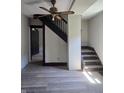 Entryway featuring a staircase with dark trim and newer flooring at 325 Harlan St, Indianapolis, IN 46201