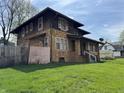 Two-story home with a stone exterior, a small porch, and a well-maintained green lawn at 3601 N Kenwood Ave, Indianapolis, IN 46208