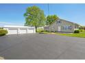 Property with a large driveway and three-car detached garage at 403 N Red Gold Dr, Trafalgar, IN 46181