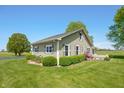 Well-maintained home with verdant landscaping and a serene outdoor space at 403 N Red Gold Dr, Trafalgar, IN 46181