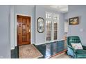 Inviting foyer with a solid wood door, light blue walls, and classic tile flooring at 424 Orchard Blvd, Danville, IN 46122