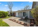 A cozy back patio featuring a charming swing and a meticulously laid brick border at 4464 Four Seasons Cir, Indianapolis, IN 46226
