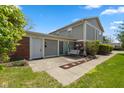 A lovely back patio with a swing and an entrance via a sliding glass door at 4464 Four Seasons Cir, Indianapolis, IN 46226