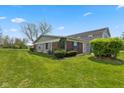 Charming home featuring a well-maintained lawn and lush landscaping on a sunny day at 4464 Four Seasons Cir, Indianapolis, IN 46226