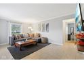 Inviting living room with a comfortable sectional sofa, neutral tones, and ample natural light at 4708 Dorkin Ct, Indianapolis, IN 46254
