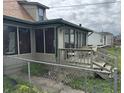 Enclosed back porch with screens and a small deck, enclosed by a chain link fence at 518 N Grant St, Lebanon, IN 46052