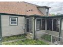The rear of the home has an enclosed porch, vinyl siding, and a well-maintained lawn at 518 N Grant St, Lebanon, IN 46052
