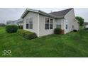 Well-maintained backyard with lush green grass and neatly trimmed shrubbery along the house perimeter at 5341 Spring Creek Ct, Indianapolis, IN 46254