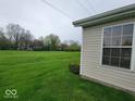 Expansive green space on the side of the house with a large window, offering a serene view of the lawn at 5341 Spring Creek Ct, Indianapolis, IN 46254