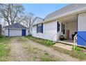 Charming home with a detached garage, blue shutters, and a welcoming front porch at 540 S Broadway St, Atlanta, IN 46031