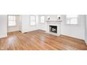 Spacious living room with hardwood floors, marble fireplace, and plenty of natural light at 5933 Guilford Ave, Indianapolis, IN 46220