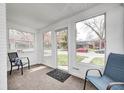 Cozy sunroom with neutral carpet, bright natural light, and inviting views of the outdoors at 5933 Guilford Ave, Indianapolis, IN 46220