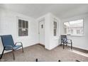 Bright sunroom featuring neutral carpet, brick walls, and large windows for ample natural light at 5933 Guilford Ave, Indianapolis, IN 46220