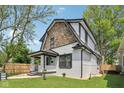 Charming two-story home features a stone accent wall, a freshly painted exterior, and a well-manicured front yard at 625 N Temple Ave, Indianapolis, IN 46201