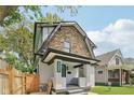 Charming two-story home features a stone accent wall, a freshly painted exterior, and a well-manicured front yard at 625 N Temple Ave, Indianapolis, IN 46201