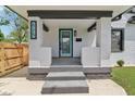 Inviting front porch featuring a vibrant door, updated lighting, and brick pillars that provide curb appeal at 625 N Temple Ave, Indianapolis, IN 46201