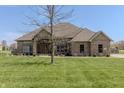Stunning single-story brick home featuring a well-maintained lawn and a mature, leafless tree in the yard at 6472 Independence Ct, Pendleton, IN 46064