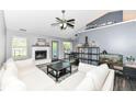 Bright living room with white sofa, fireplace, decor and view into dining area at 7332 Quartz Rock Rd, Indianapolis, IN 46236
